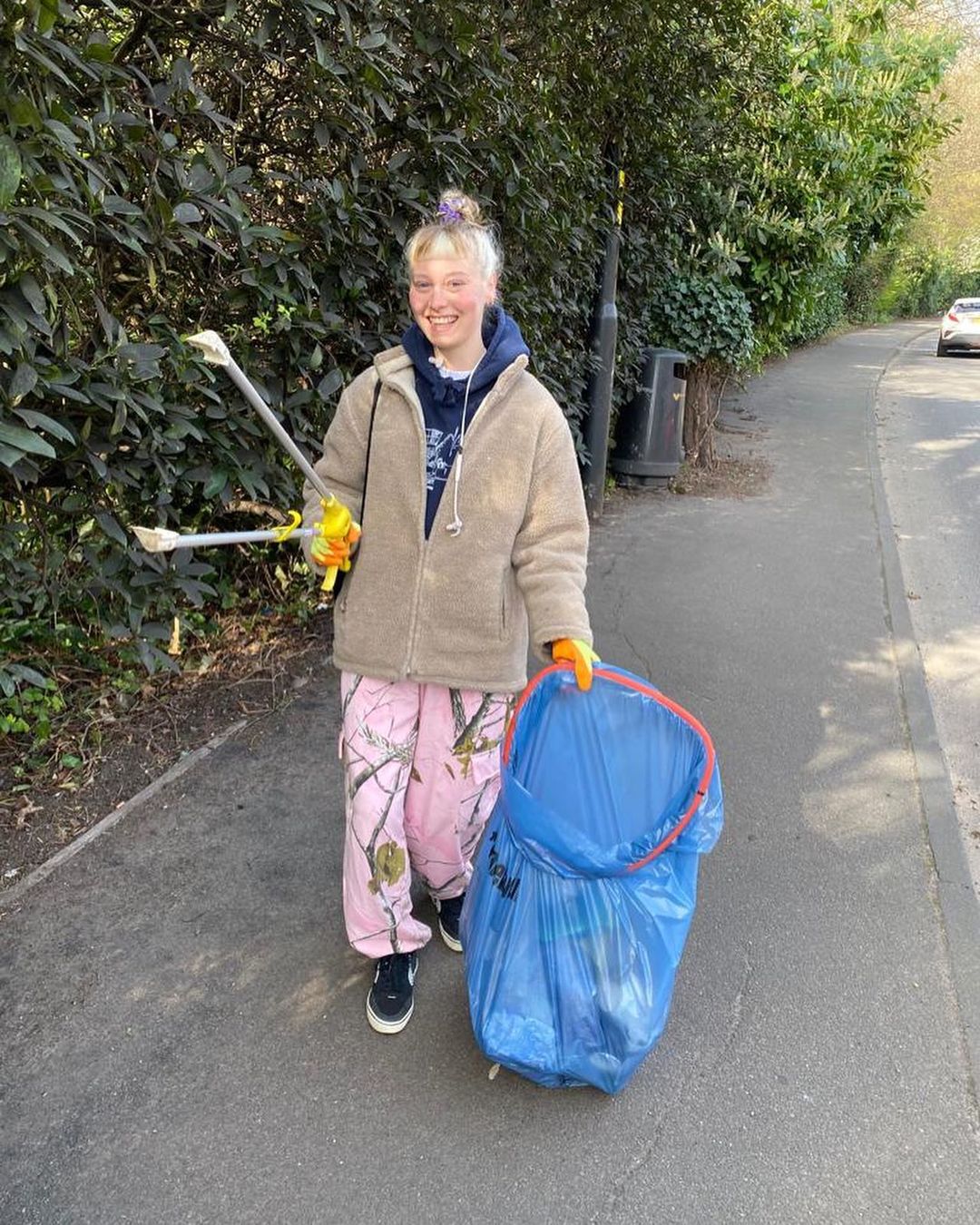 Empress Linoleum, a Birmingham-based musician, smiling on a litter pick. 