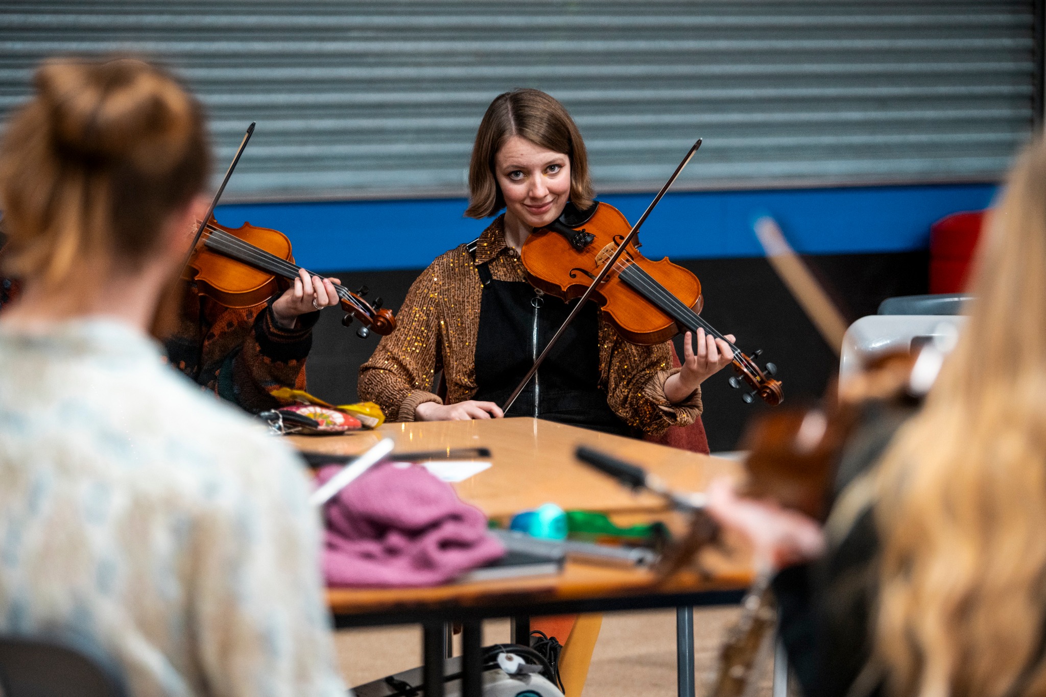 a young woman plays a violin