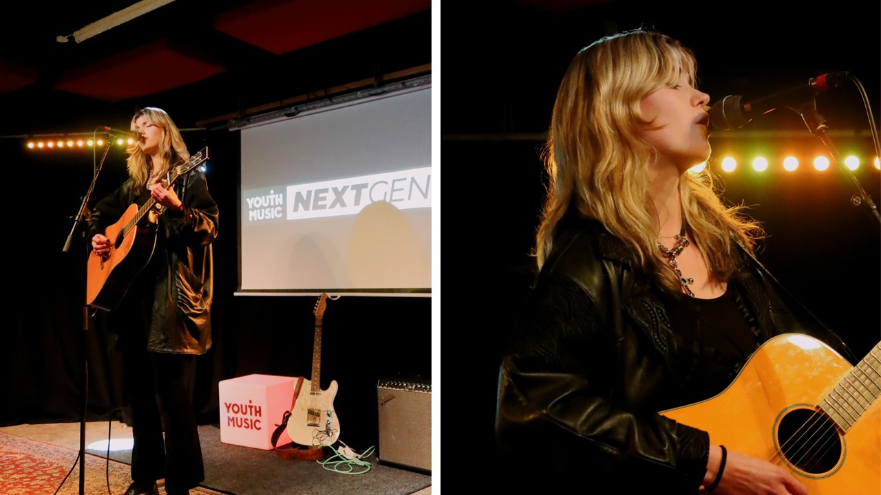 a musician performs on stage with a guitar during the open mic