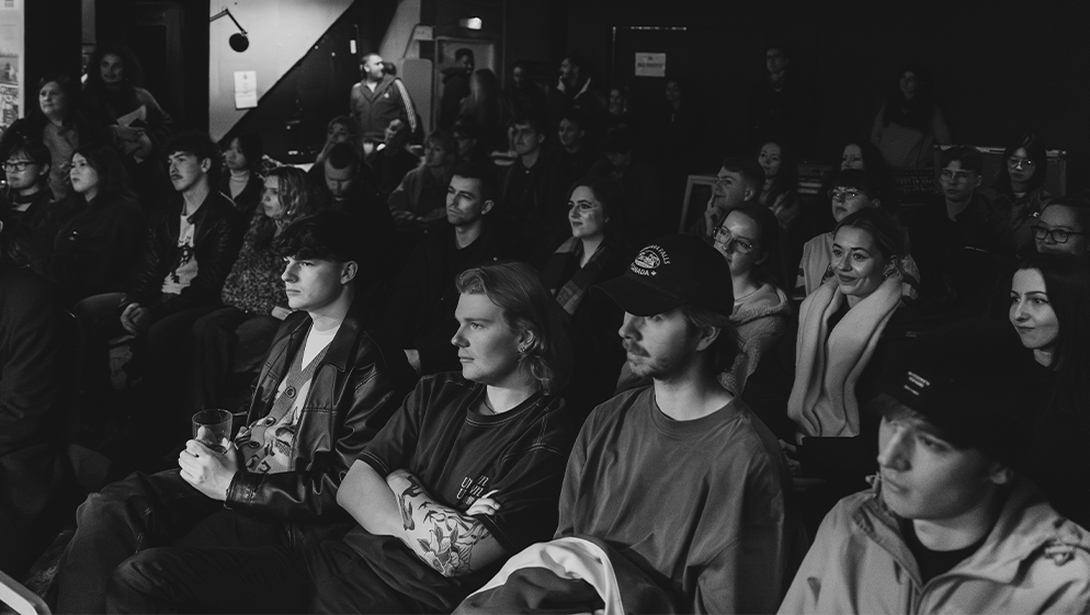 the audience watches the panel