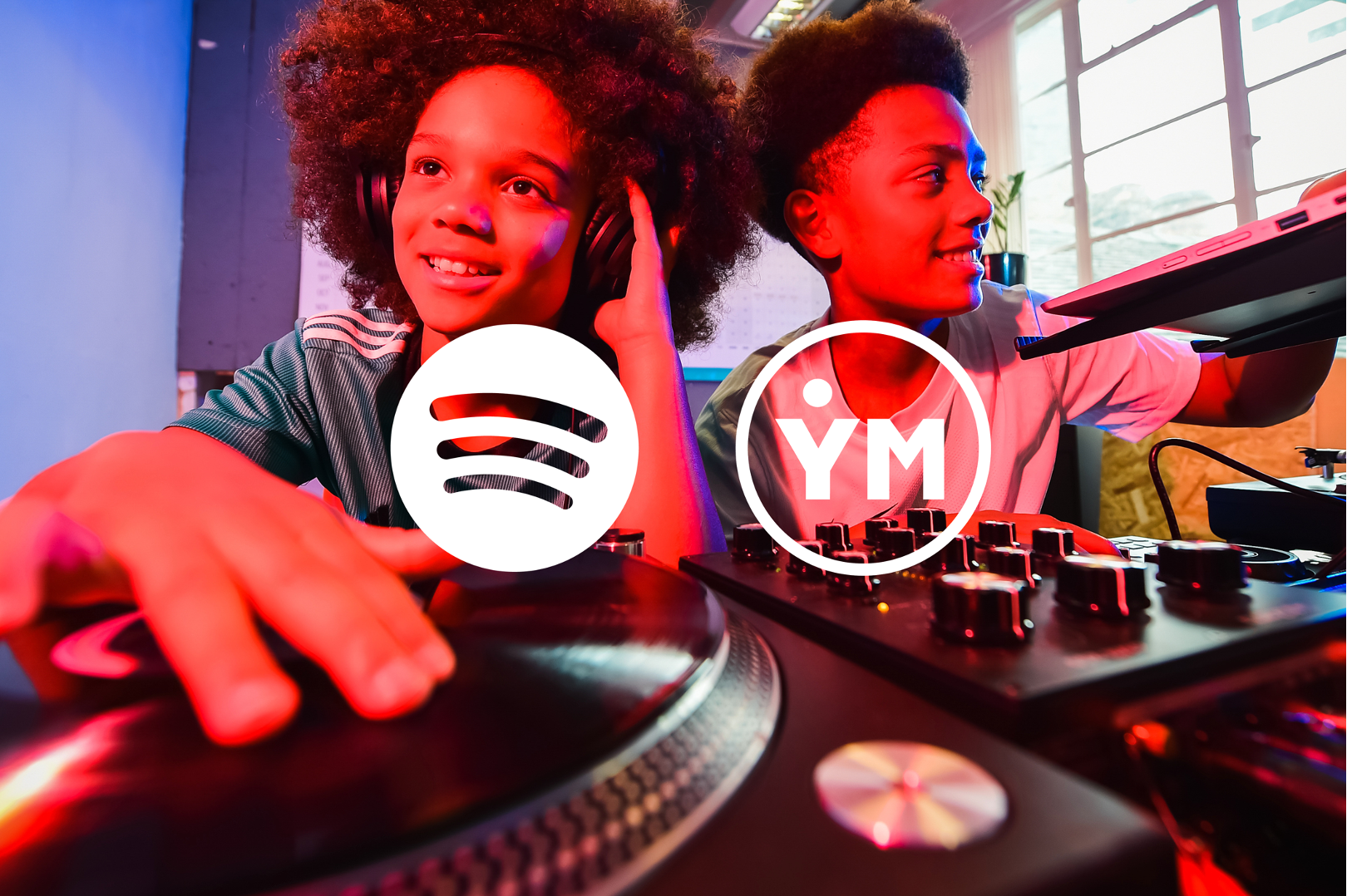 two boys play with DJ equipment. the spotify and youth music logos are burnt in