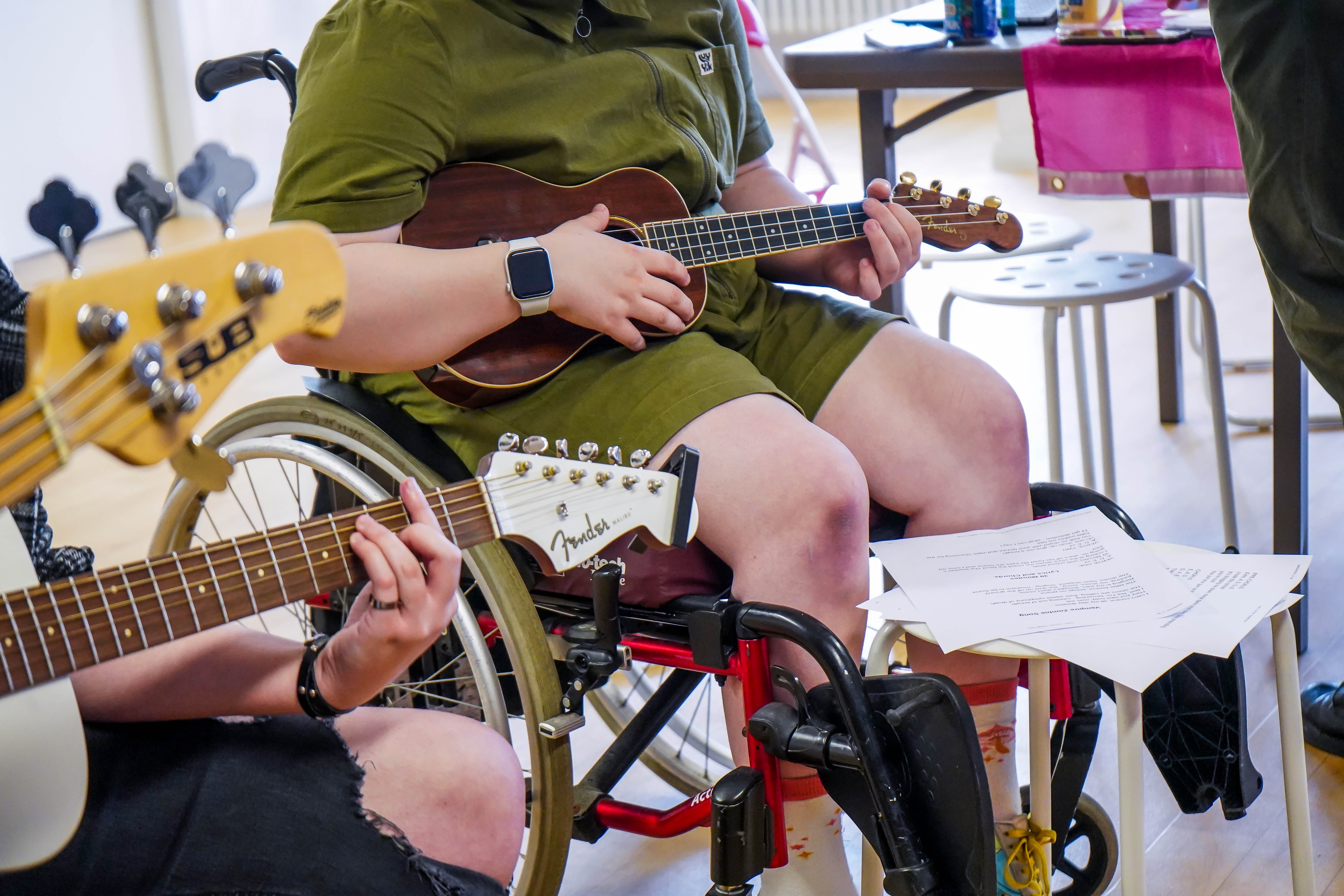 Image of a young person playing a ukulele