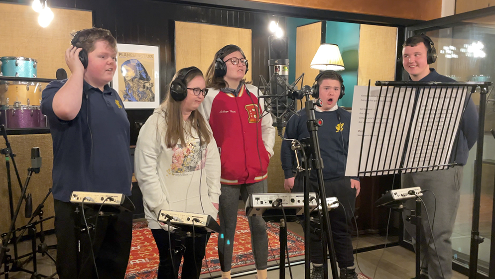 a group of young people from square pegs arts sing in a recording studio