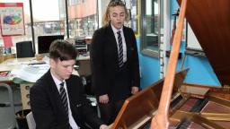 Charlotte and Finlay at a piano