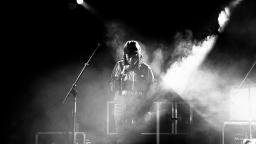 young musician standing on stage. black and white photo.