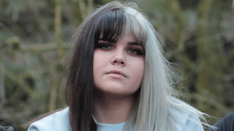 Woman with dark hair on one side, bleached on the other