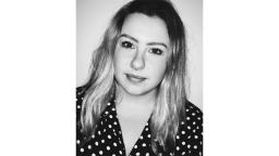 black and white headshot of girl wearing polkadot shirt