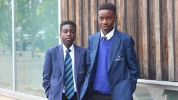 Two boys wearing blue school uniform