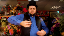 Man in a bowler hat and waistcoat in a flower shop