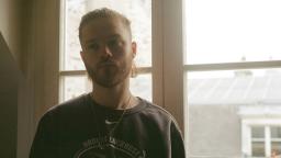 young person standing in front of window