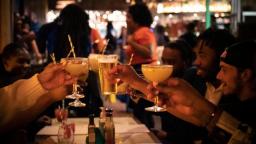 a group of people clinking glasses together over a table