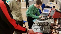 a young boy plays with musical equipment