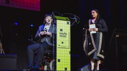 Elizabeth J. Birch on stage with award presenter Dr. Diljeet Kaur Bhachu 