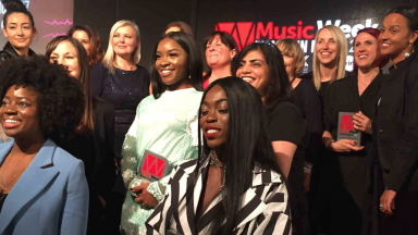 Group of women on stage in front of Music Week logo