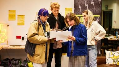 four young people working at an event