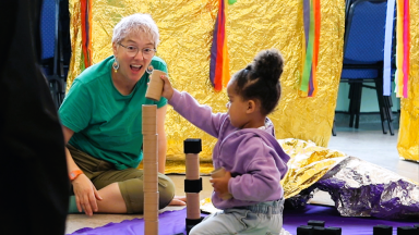 a young child plays with building blocks