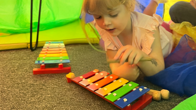 a girl plays a xylophone