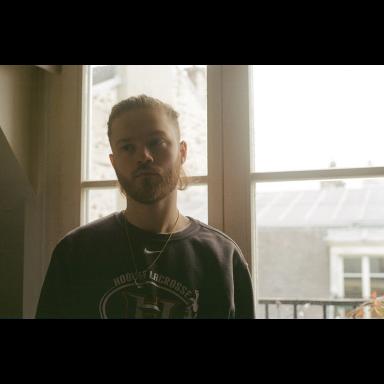 man standing next to window 