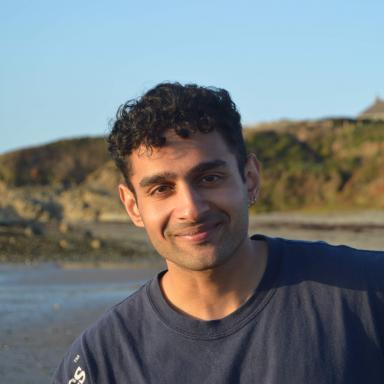 Michael smiling with a beach in the background