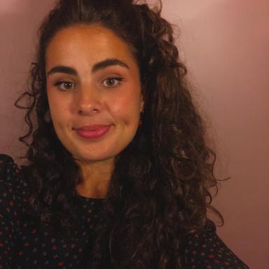 Woman with long curly hair and black top