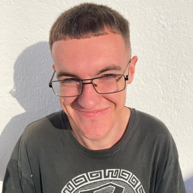 a man with glasses and grey t shirt