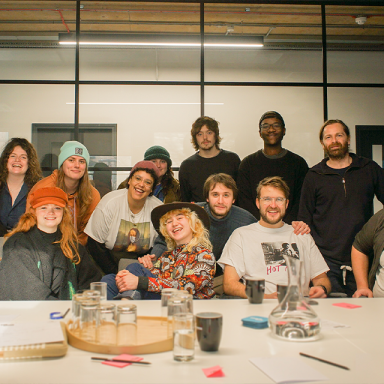 a group of people pose together in a meeting room