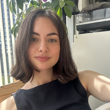 a woman with brown cropped hair takes a selfie