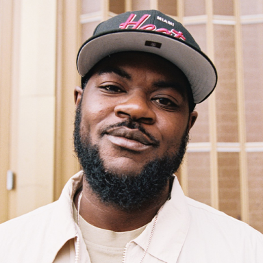 a man wears a white shirt and a cap